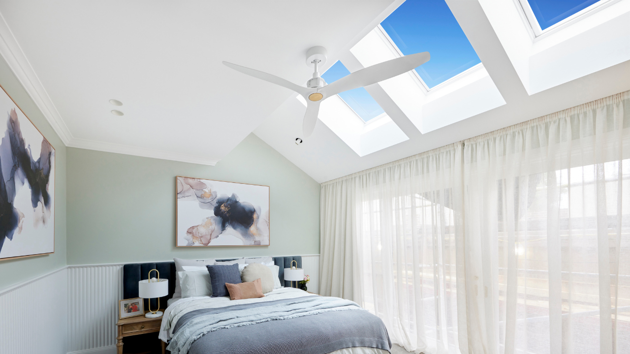3 skylights over bedroom with ceiling fan