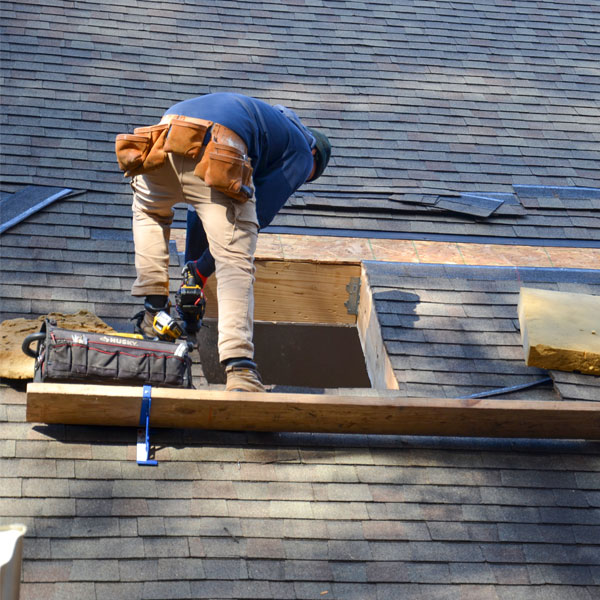Skylight installer on a roof